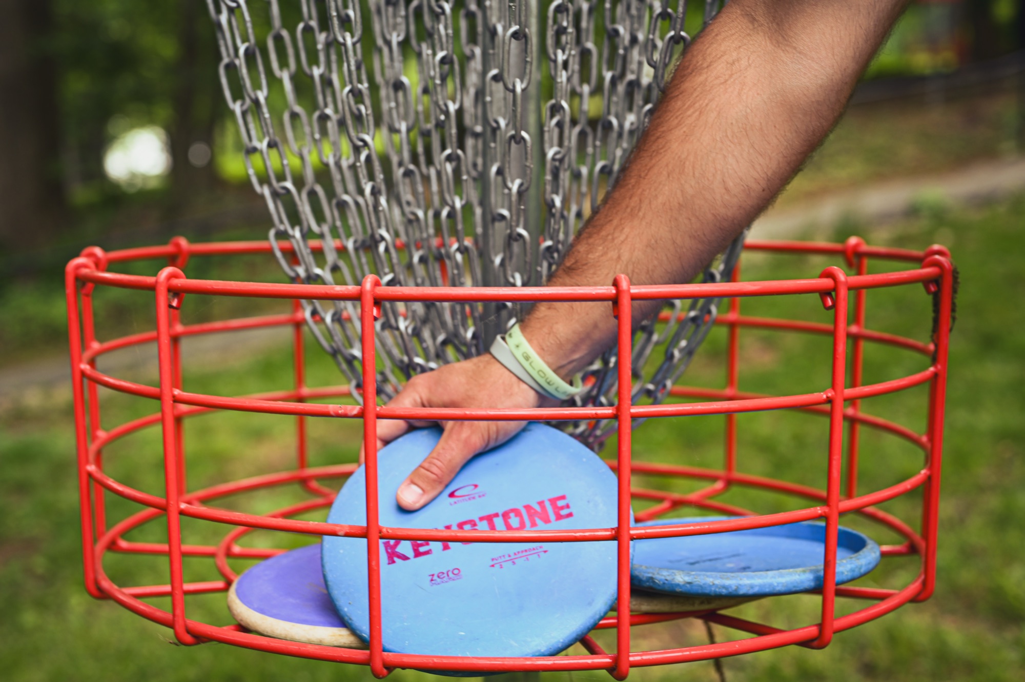 Pulling discs from the basket after a made putt